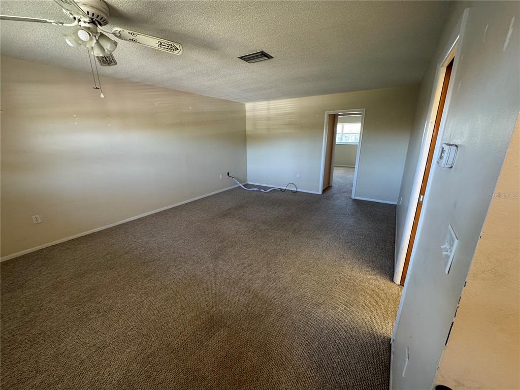245 Center Road, Unit 211 Venice, FL 34285 - Photo 4 of 9 an empty room with a mirror