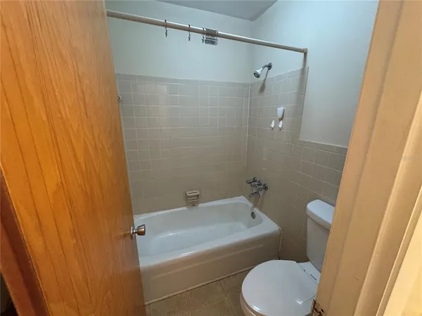 a bathroom with a toilet and shower