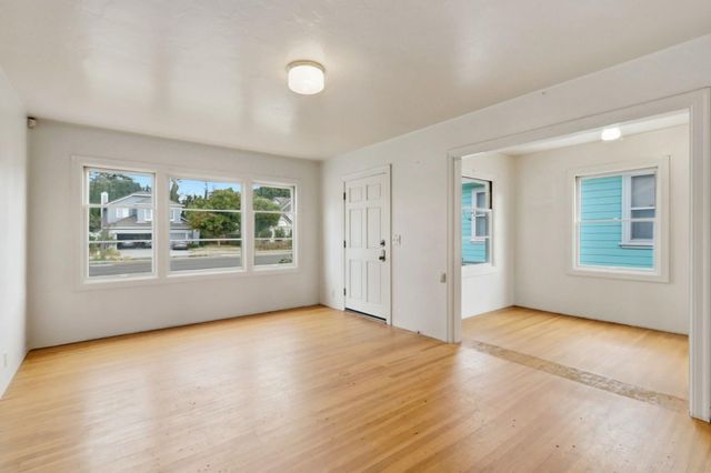 a large bathroom with a sink and a refrigerator