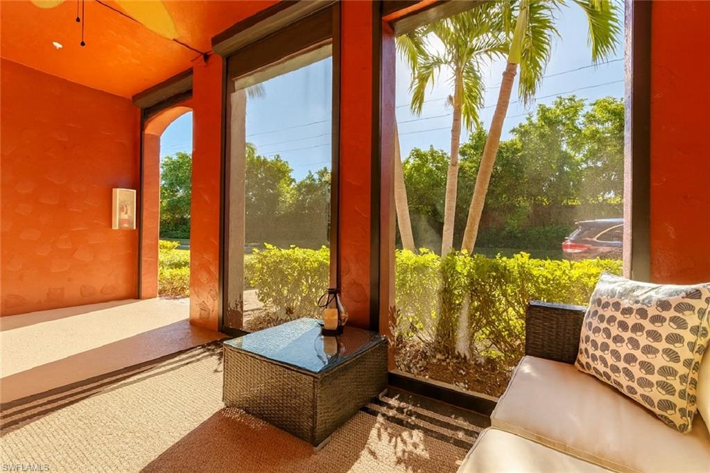 9055 Capistrano Street North, Unit 4206 Naples, FL 34113 - Photo 13 of 45 a living room with furniture and a large window