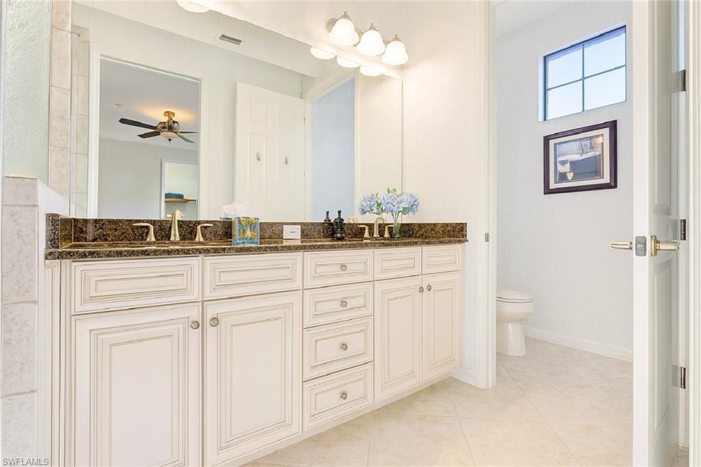 9055 Capistrano Street North, Unit 4206 Naples, FL 34113 - Photo 19 of 45 a bathroom with a sink vanity and a mirror
