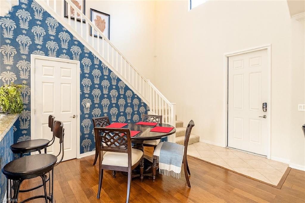 9055 Capistrano Street North, Unit 4206 Naples, FL 34113 - Photo 6 of 45 a dining room with furniture and wooden floor