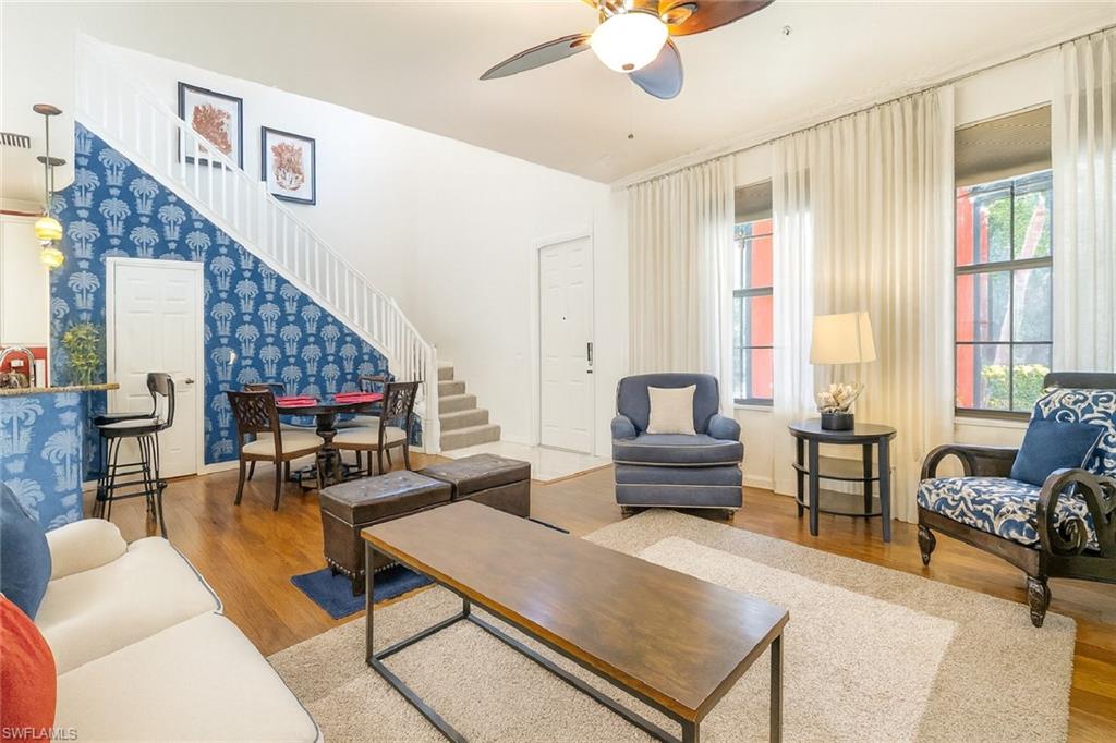 9055 Capistrano Street North, Unit 4206 Naples, FL 34113 - Photo 7 of 45 a living room with furniture and a large window