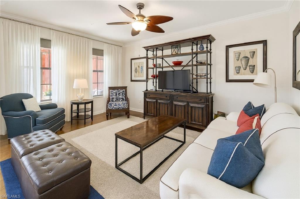 9055 Capistrano Street North, Unit 4206 Naples, FL 34113 - Photo 10 of 45 a living room with furniture a flat screen tv and a window