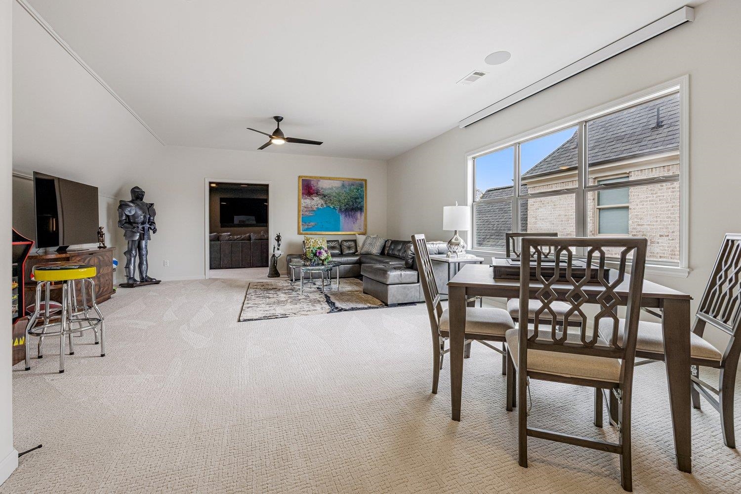 262 Beckham Drive Collierville, TN 38017 - Photo 22 of 32 a living room with furniture a flat screen tv and kitchen view