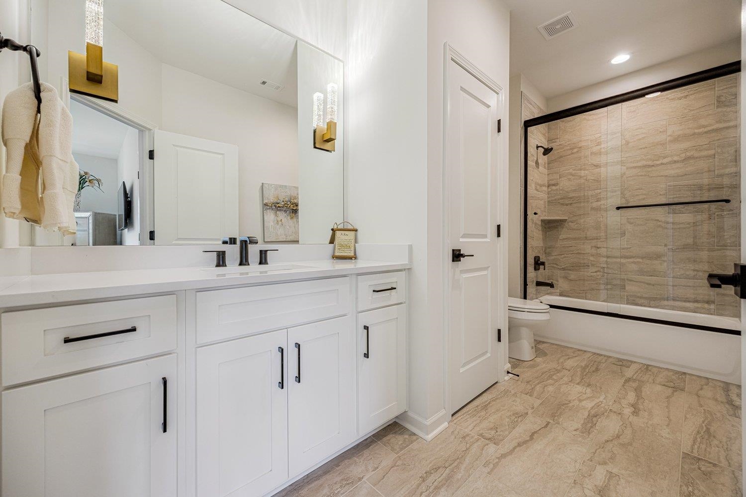 262 Beckham Drive Collierville, TN 38017 - Photo 28 of 32 a bathroom with a double vanity sink a mirror and a shower