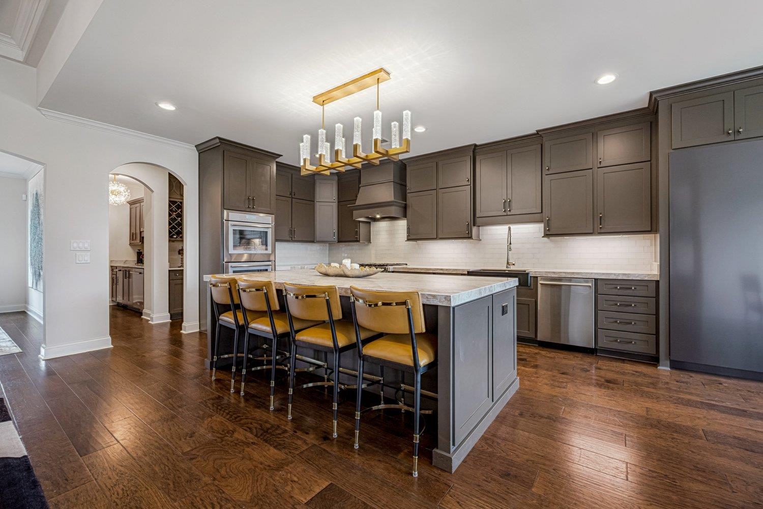 262 Beckham Drive Collierville, TN 38017 - Photo 7 of 32 a kitchen with stainless steel appliances a table chairs sink and cabinets