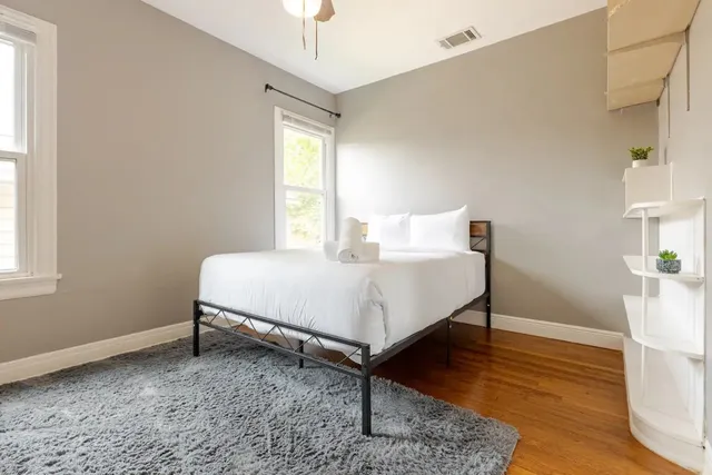 a bedroom with a bed and a chandelier