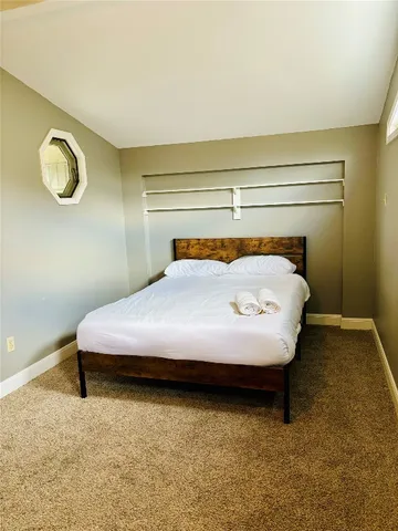 a bedroom with a bed and a table