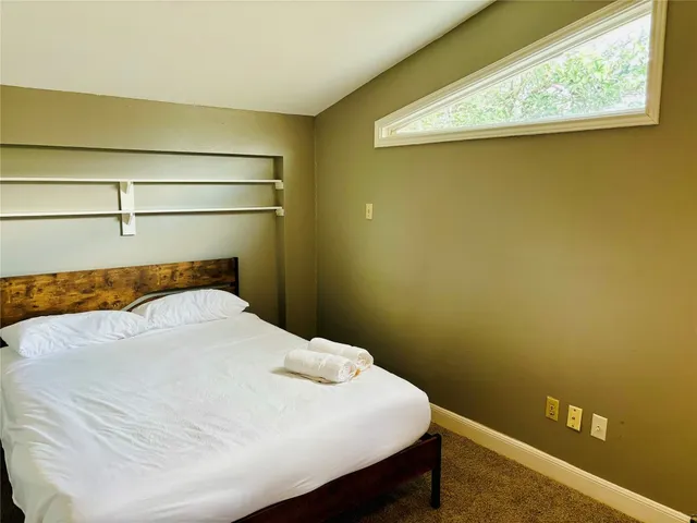 a bedroom with a bed and window