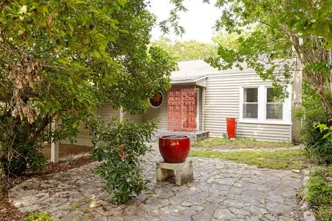 a view of a backyard with plants and patio