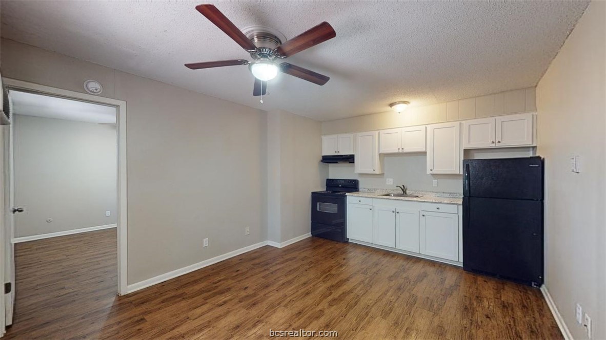 500 Foch Street, Unit 13 Bryan, TX 77801 - Photo 2 of 12 a kitchen with a refrigerator and a stove top oven