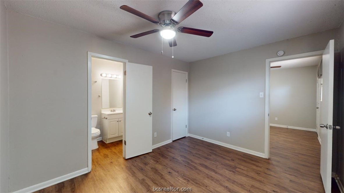 500 Foch Street, Unit 13 Bryan, TX 77801 - Photo 6 of 12 an empty room with wooden floor and a ceiling fan
