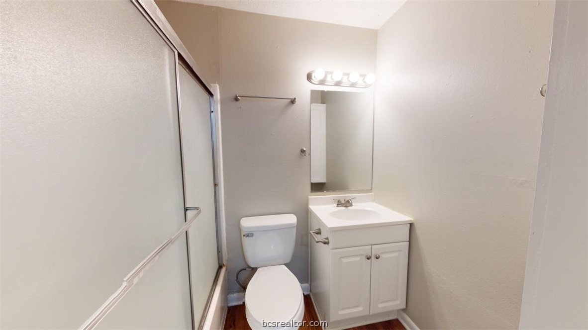 500 Foch Street, Unit 13 Bryan, TX 77801 - Photo 8 of 12 a bathroom with a toilet sink and mirror