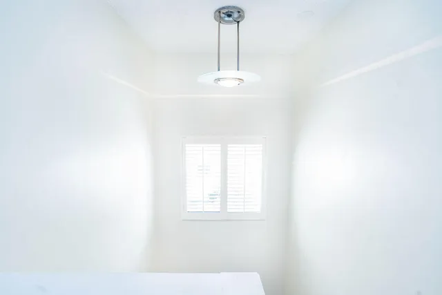 a view of an empty room with windows