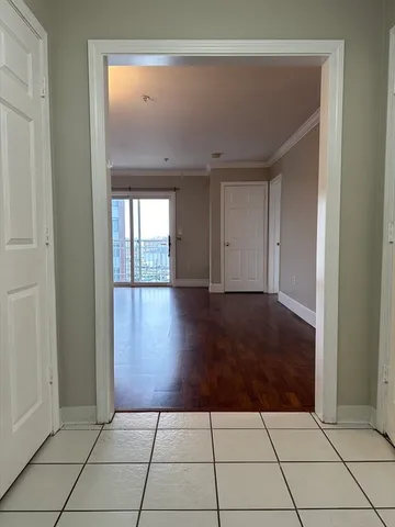 a view of a hallway with wooden floor