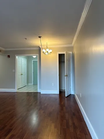 an empty room with a ceiling fan and windows