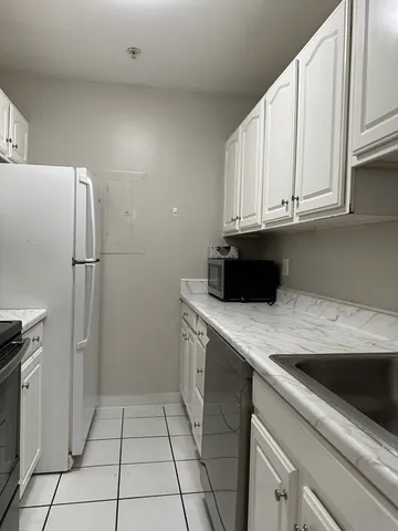 a kitchen with a sink and a refrigerator