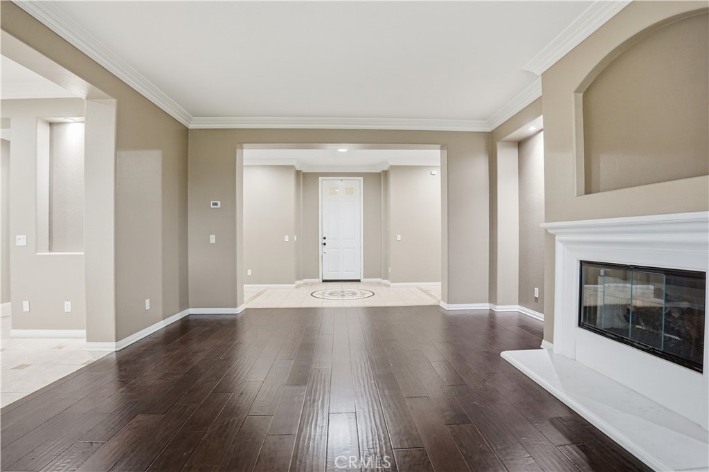 16935 Eagle Peak Road Riverside, CA 92504 - Photo 12 of 75 a view of an empty room with wooden floor and fireplace
