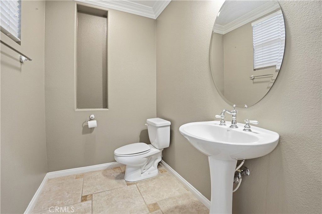 16935 Eagle Peak Road Riverside, CA 92504 - Photo 14 of 75 a bathroom with a sink a mirror and a toilet