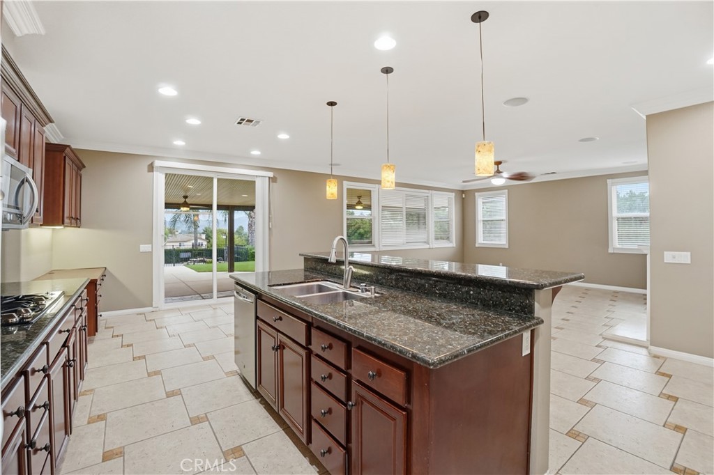 16935 Eagle Peak Road Riverside, CA 92504 - Photo 20 of 75 a kitchen with granite countertop a stove a sink a oven and a granite counter tops
