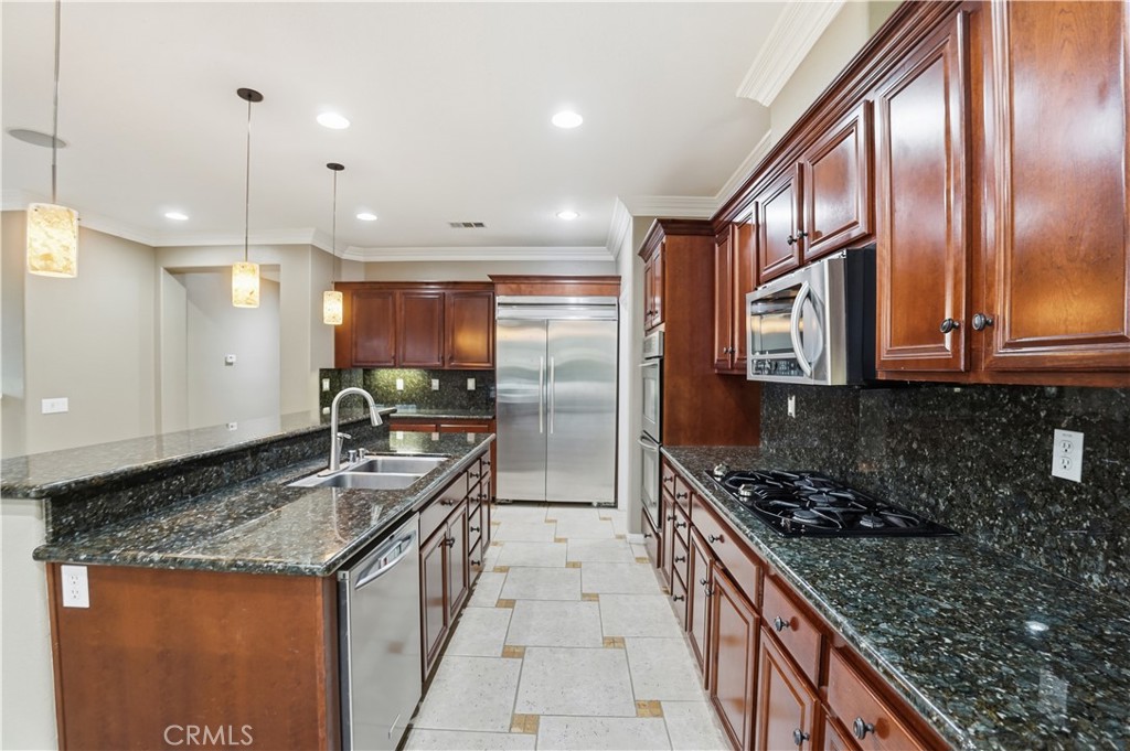 16935 Eagle Peak Road Riverside, CA 92504 - Photo 23 of 75 a kitchen with stainless steel appliances granite countertop a stove a sink and a refrigerator