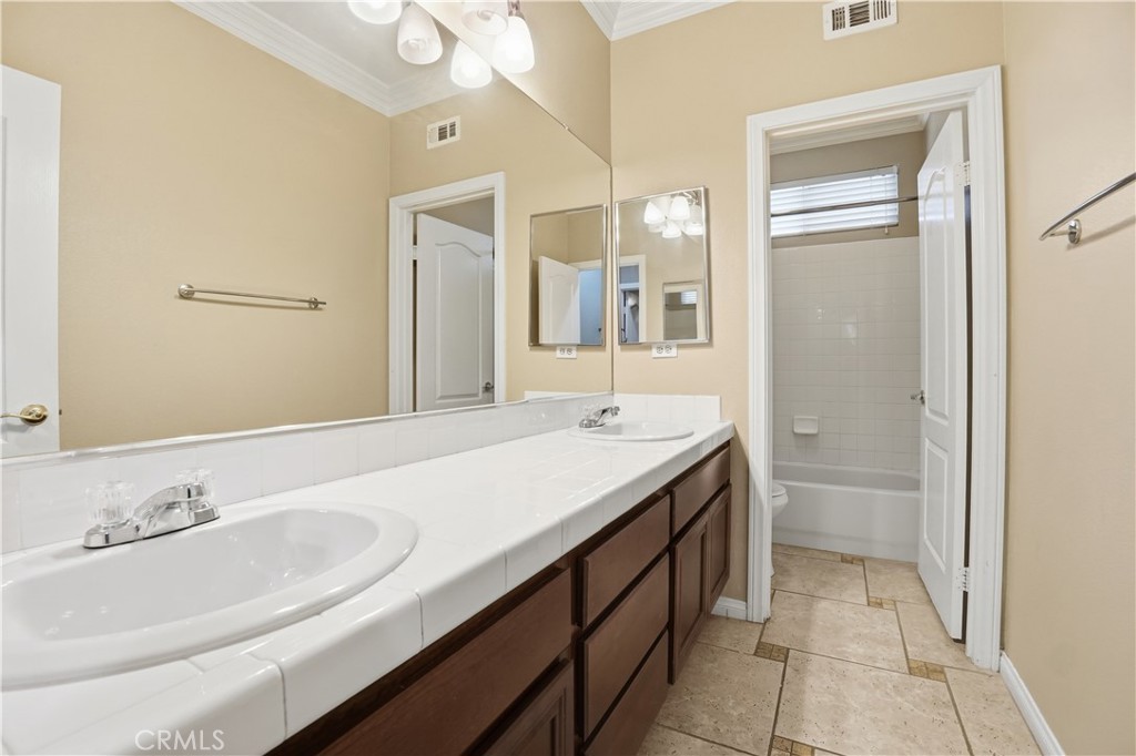 16935 Eagle Peak Road Riverside, CA 92504 - Photo 42 of 75 a bathroom with a granite countertop sink and a mirror