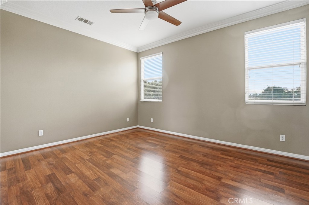 16935 Eagle Peak Road Riverside, CA 92504 - Photo 44 of 75 an empty room with wooden floor and windows