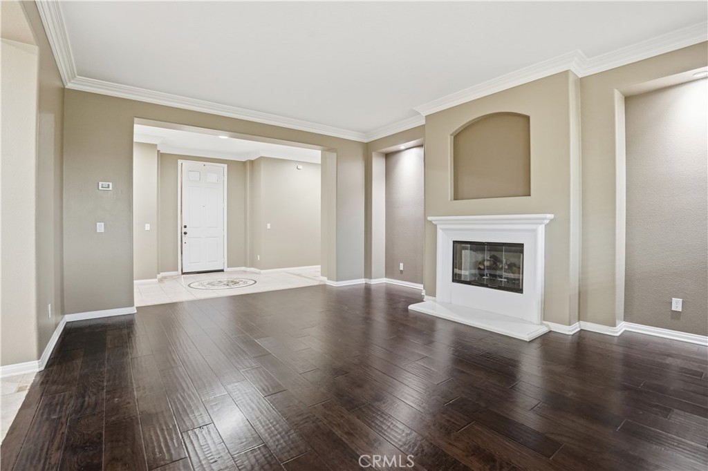16935 Eagle Peak Road Riverside, CA 92504 - Photo 9 of 75 a view of a livingroom with wooden floor and a fireplace