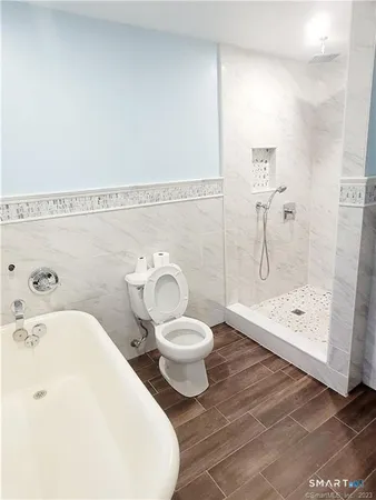 a white toilet sitting next to a bathroom sink