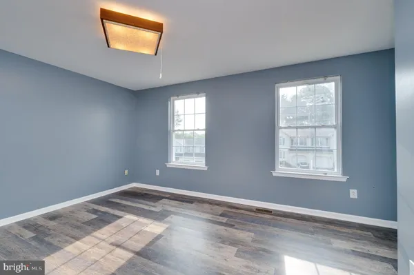 a view of a room that has a window and a ceiling fan