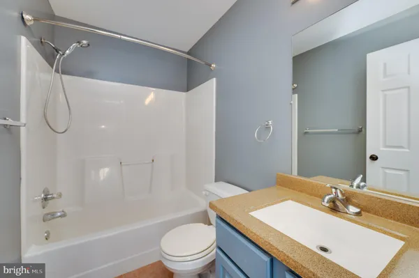 a bathroom with a sink toilet tub and shower