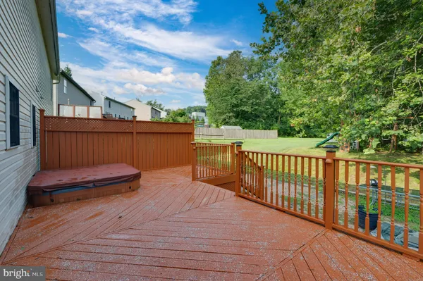 a view of a roof deck with wooden fence