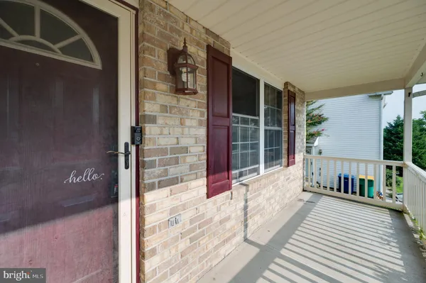a balcony with couch and wooden floor