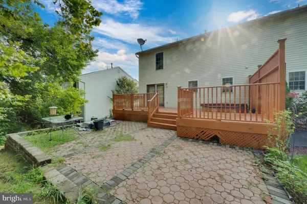 a backyard of a house with garden and deck