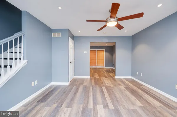 a view of empty room with wooden floor