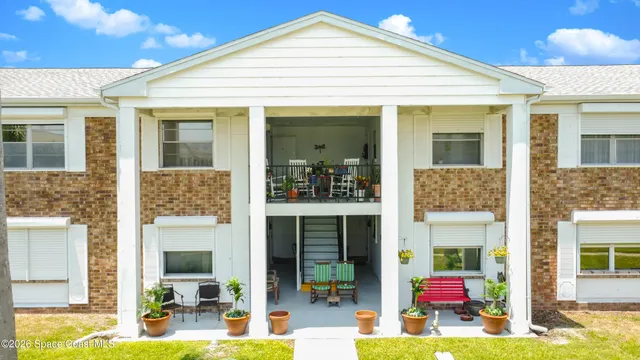 a view of a patio with table and chairs and potted plants