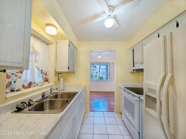 a kitchen with stainless steel appliances a sink a stove and a refrigerator