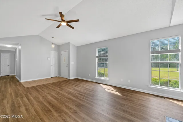 a view of a livingroom with a ceiling fan and window