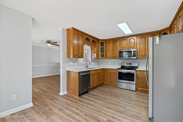 a kitchen with granite countertop a refrigerator stove and oven