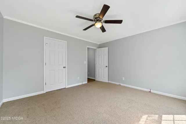 a view of a livingroom with a ceiling fan and window