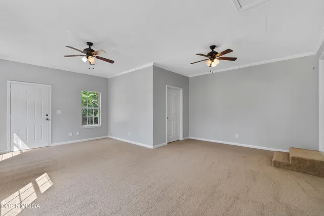 an empty room with a ceiling fan and a window