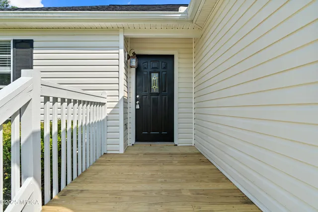 a view of a porch with wooden floor