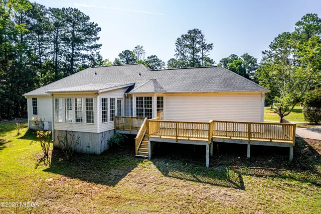 a view of a house with swimming pool and porch with furniture