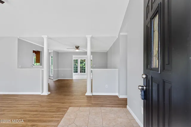 a view of an entryway with wooden floor and a cabinet