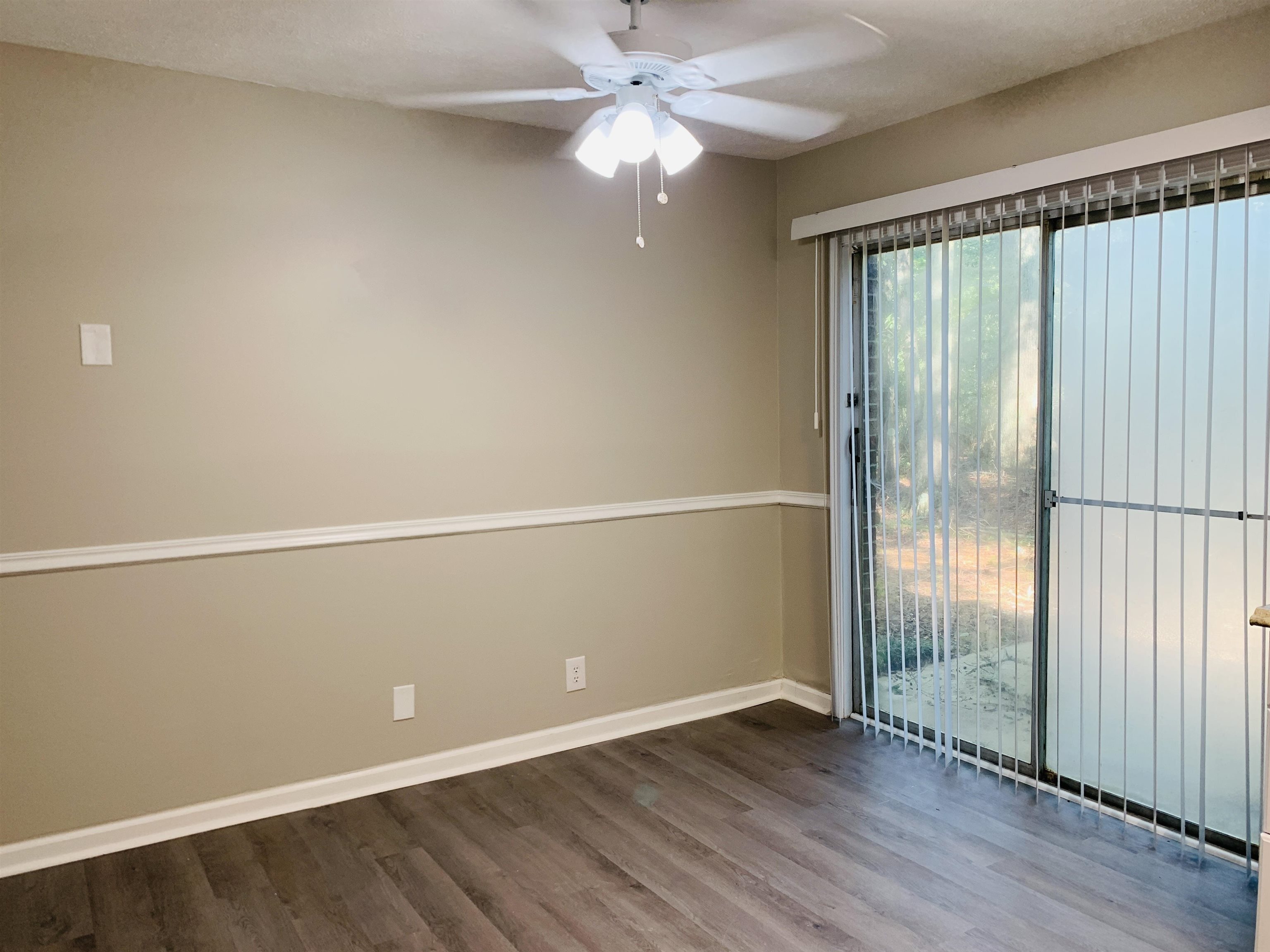 118 Lafayette Court, Unit 118 LaGrange, GA 30241 - Photo 12 of 21 wooden floor in an empty room with a window