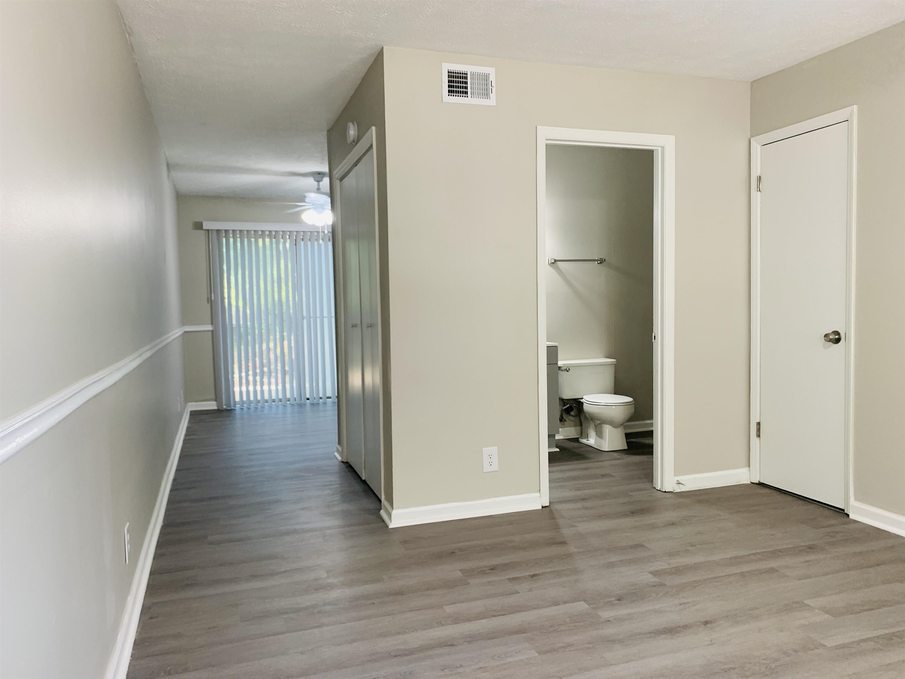 118 Lafayette Court, Unit 118 LaGrange, GA 30241 - Photo 6 of 21 a view of a hallway with wooden floor and a bathroom