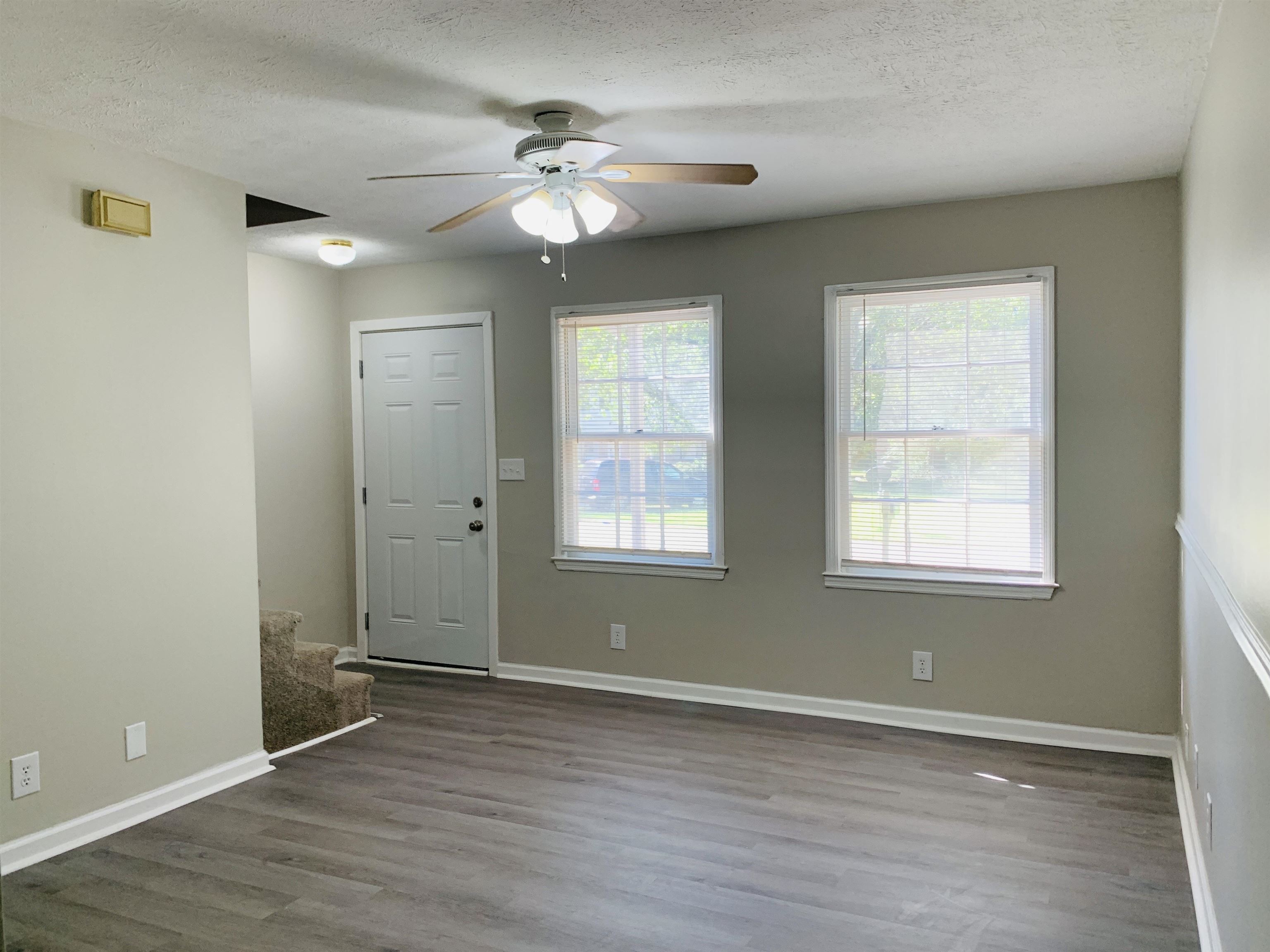 118 Lafayette Court, Unit 118 LaGrange, GA 30241 - Photo 7 of 21 a view of an empty room with wooden floor and a window