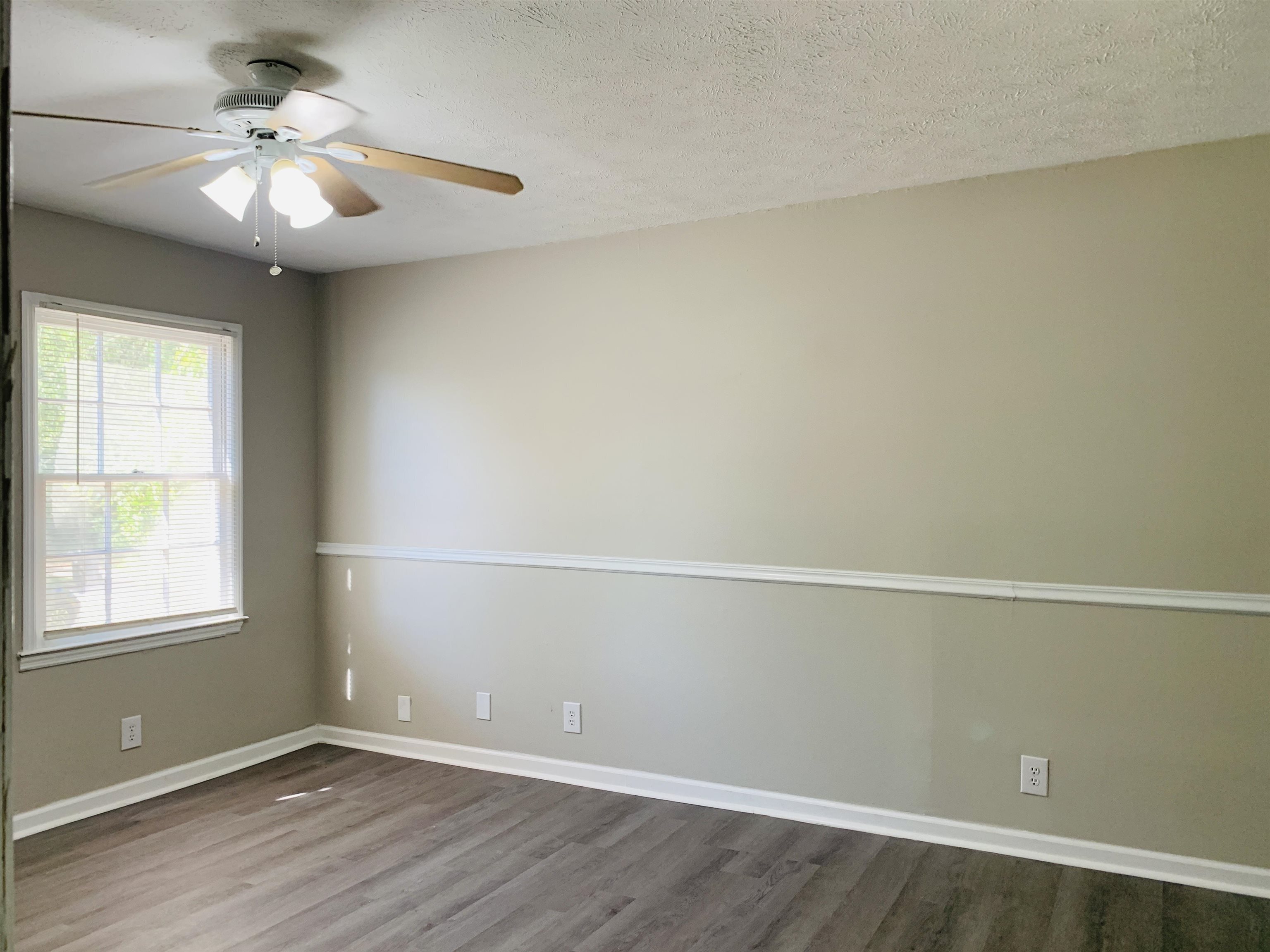 118 Lafayette Court, Unit 118 LaGrange, GA 30241 - Photo 8 of 21 an empty room with a window and a ceiling fan