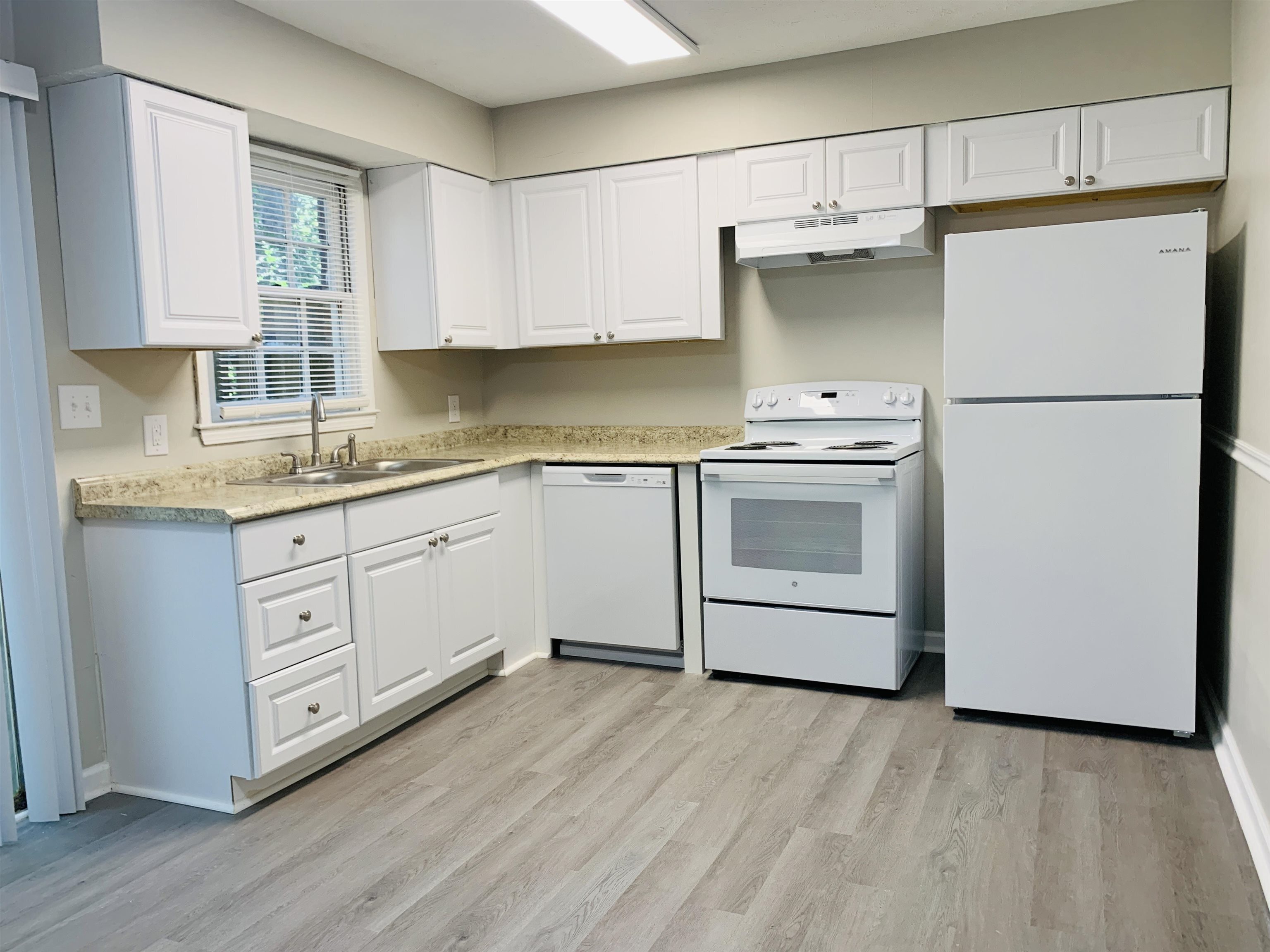 118 Lafayette Court, Unit 118 LaGrange, GA 30241 - Photo 10 of 21 a kitchen with white cabinets and white appliances